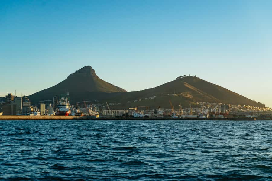 Cape Town: Sunset Champagne Cruise and 3-Course Dinner - Two glasses, music, and a social atmosphere
